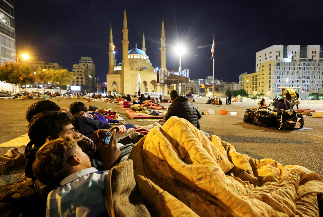Above, displaced people rest in their temporary shelter at Martyrs’ Square in the city center, where many people spend the night fleeing the ongoing Israeli strikes in southern Beirut on Oct. 30, 2024. (Reuters)