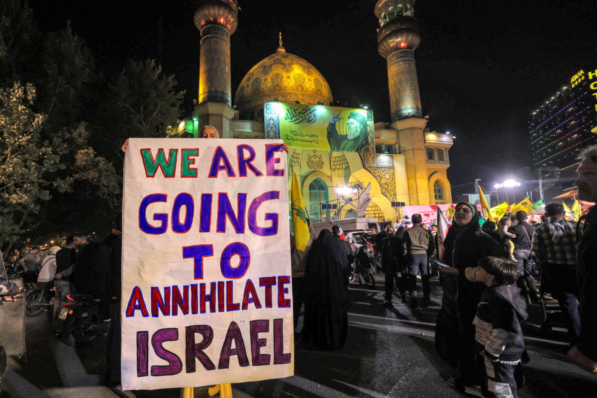 Iranians celebrate in Tehran on Oct. 1, 2024, after Iran launched a barrage of missiles at Israel. (AFP)