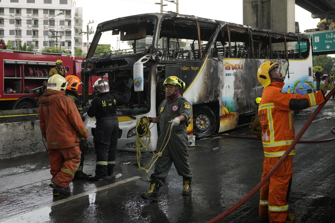 Rescuers work at the site of a bus that caught fire, carrying young students with their teachers, in suburban Bangkok, Tuesday, Oct. 1, 2024. (AP)