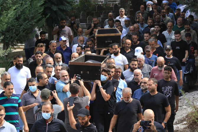 Mourners march to a cemetery in the city of Sidon in southern Lebanon on October 1, 2024 with the bodies of victims of an Israeli air strike on the town of Ain al-Delb. Lebanon's health ministry said on September 30 that 45 people were killed and 70 wounded in the bombardment of Ain al-Delb. (AFP)