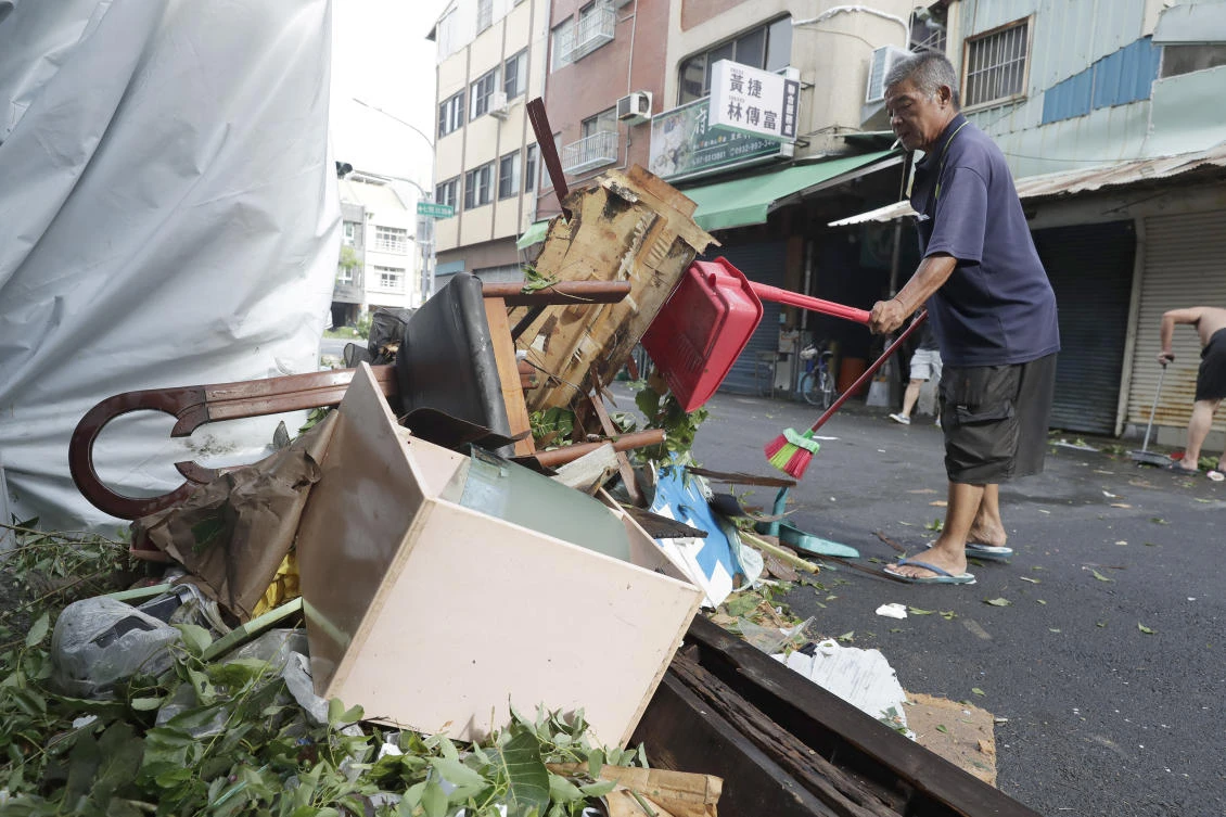 Typhoon Krathon hit land in the southwestern city of Kaohsiung, inundating streets, blowing out the windows of some buildings and scattering debris amid record-breaking winds. (AP)