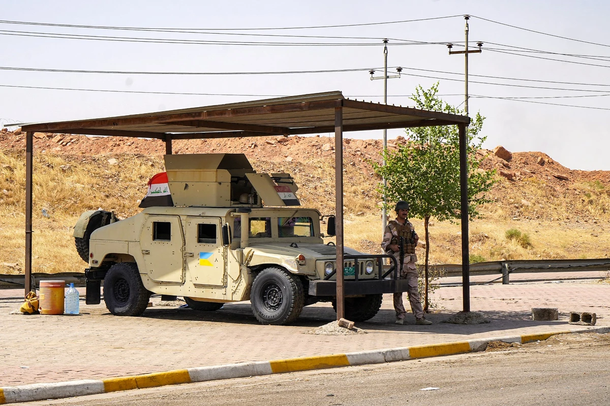 A humvee (HMMWV) vehicle of the Iraqi security forces is stationed at a checkpoint along a road in Iraq's multi-ethnic northern city of Kirkuk (disputed between Iraqi Kurdistan and Baghdad) on September 5, 2023 (AFP)
