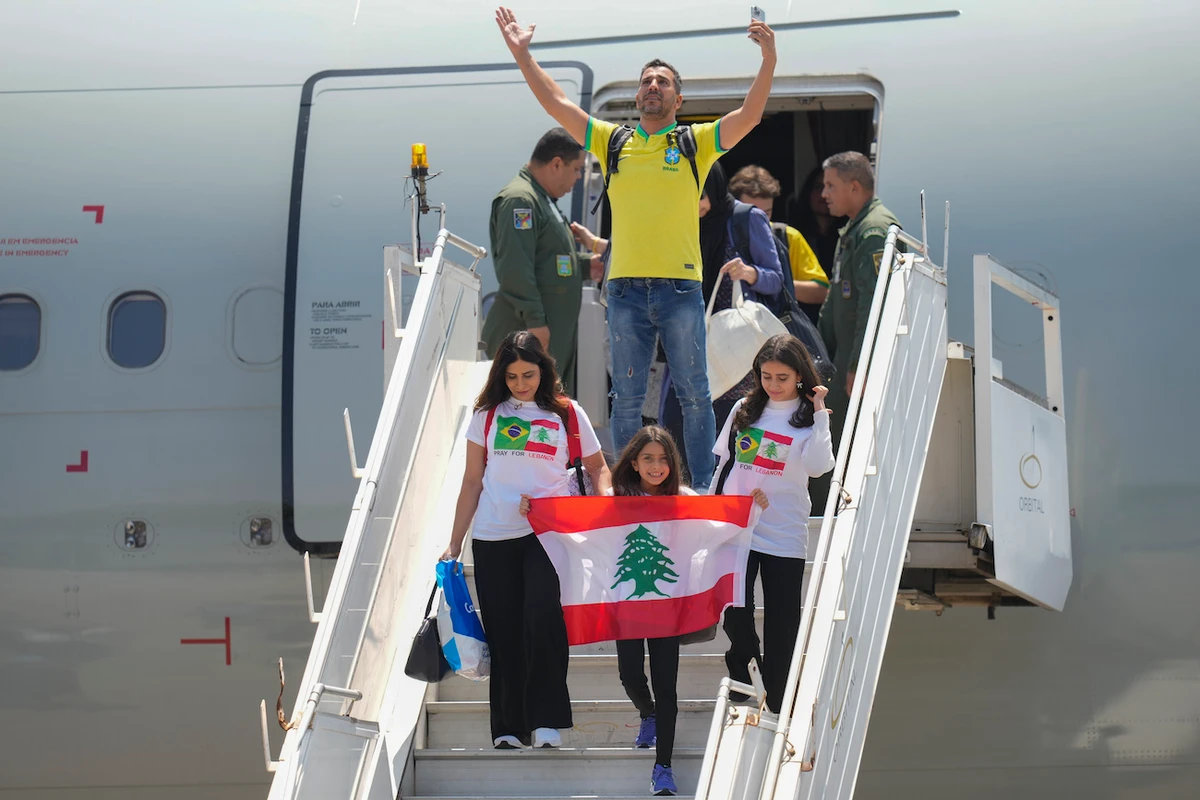Brazilians deplane after the Air Force evacuated them from Lebanon amid Israeli airstrikes, at the Air Force base in Guarulhos, greater Sao Paulo area, Brazil, Sunday, Oct. 6, 2024. (AP)