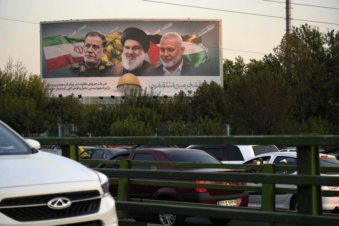 Billboard in Tehran shows slain Hezbollah leader Hassan Nasrallah, late Hamas leader Ismail Haniyeh, and the late Iranian Revolutionary Guard Gen. Abbas Nilforushan, who was killed in an Israeli airstrike. (AP)