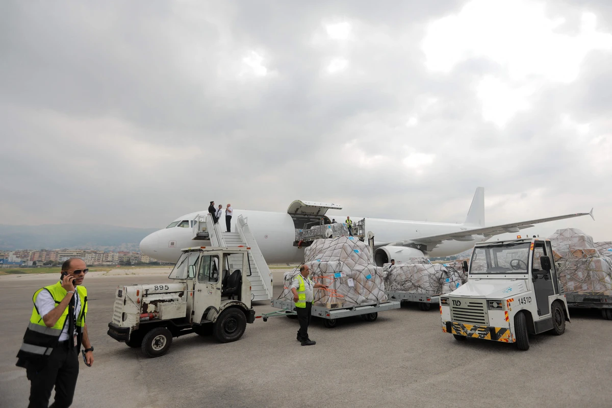 Aid workers supervise as airport workers unload humanitarian aid provided by UK Aid and theUNICEF at Beirut International airport on Sunday. AFP