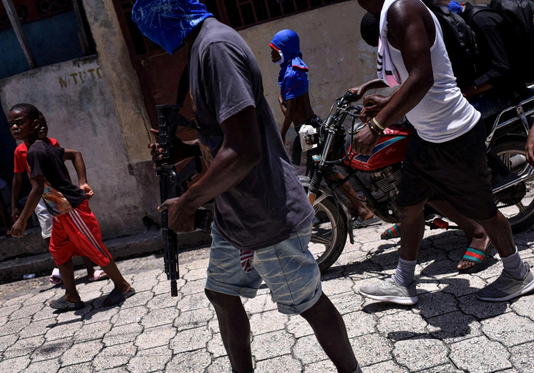 Children accompany armed gang members in a march in the Delmas neighborhood of Port-au-Prince, Haiti on May 10, 2024. (Reuters)