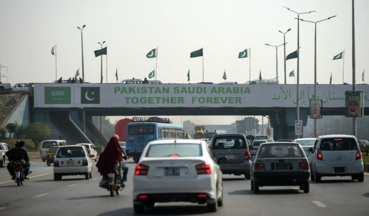 In this file photo, taken on Feb. 15, 2019, Pakistani commuters drive their vehicles under a banner welcoming Saudi Arabia’s Crown Prince Mohammed bin Salman displayed on a bridge, ahead of his arrival in 2019, in Islamabad. AFP/File