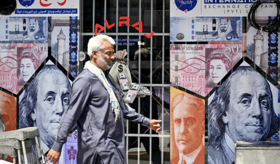 A man walks past a currency exchange shop in Rawalpindi on June 12, 2024. AFP/File