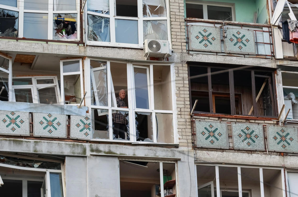A resident stands on the balcony of an apartment building damaged by a Russian drone strike in the city of Chornomorsk, Odesa region, Ukraine on Oct. 9, 2024. (Reuters)