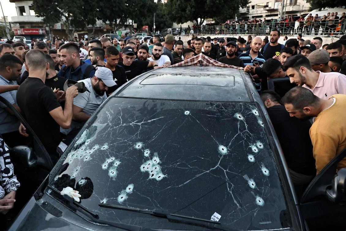 People inspect the bullet-riddled car in which four Palestinians were reportedly killed by Israeli special forces in Nablus in the occupied West Bank on October 9, 2024. Israel launched a large-scale operation early on August 28, with coordinated raids across four northern West Bank cities — Jenin, Nablus, Tubas and Tulkarem — as the army said it killed nine militants as the nearly 11-month-old Gaza war showed no signs of abating. (AFP)