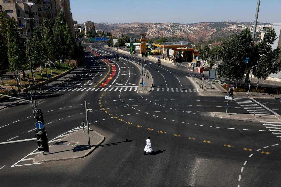 A person walks at an empty street on Yom Kippur, the Jewish day of atonement and the holiest day in the Jewish calendar, amid the ongoing conflict between Israel and Hamas in Gaza and the hostilities between Hezbollah and Israeli forces, in Jerusalem, on Oct. 12, 2024. (Reuters)