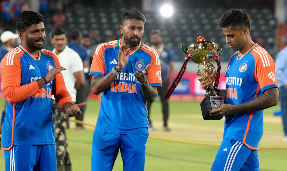 Indian captain Suryakumar Yadav with the trophy as teammates Hardik Pandya and Sanju Samson applaud, after winning the T20 cricket series against Bangladesh in Hyderabad Saturday. (AP)