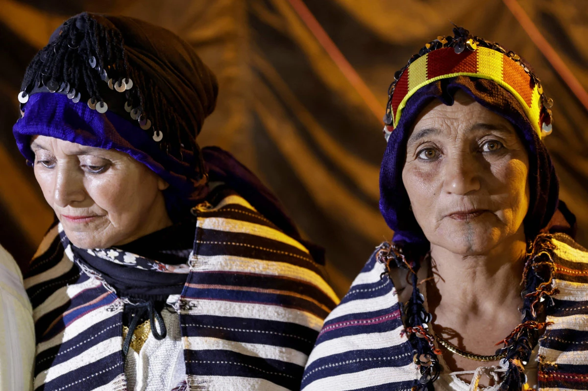 Amazigh women show their tattooed chin in the village of Imilchil in central Morocco's High Atlas Mountains on September on August 19, 2024. Many attribute the near-disappearance of facial tattoos to Morocco's changing religious attitudes in recent decades, with interpretations of Islam where inked skin and other body modifications like piercings are prohibited taking hold. (AFP)