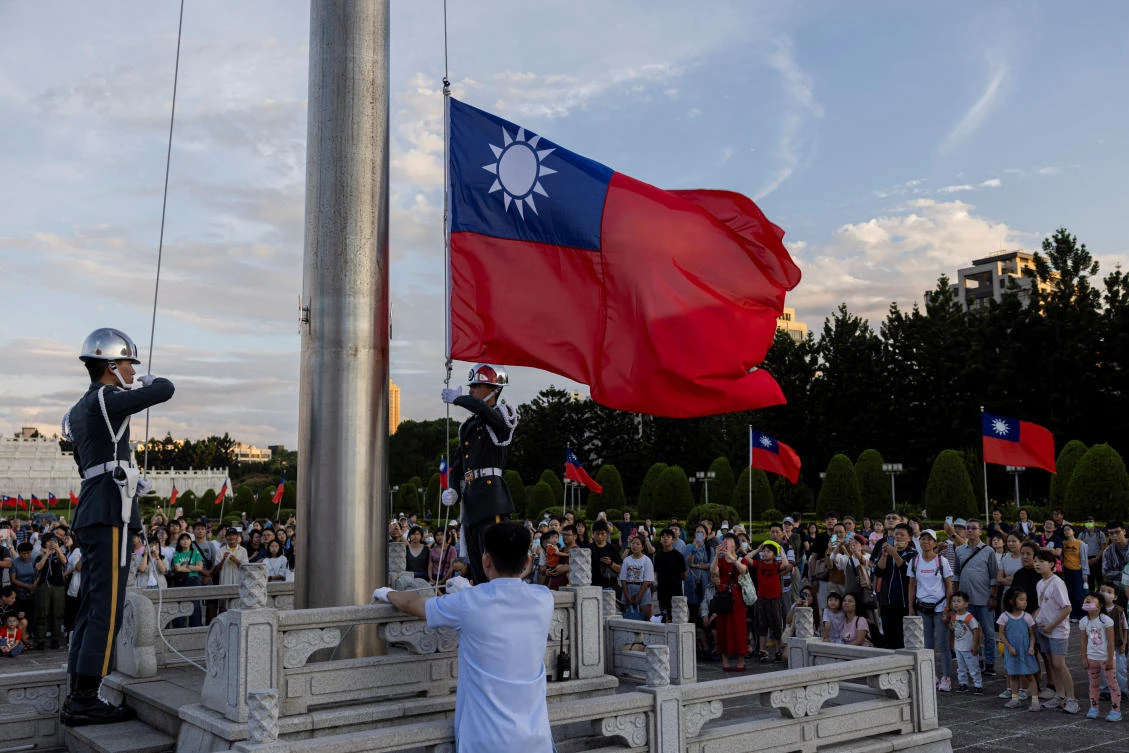 Honor guards lower the Taiwanese flag during a ceremony at Chiang Kai-shek Memorial Hall in Taipei, Taiwan October 12, 2024. (REUTERS)