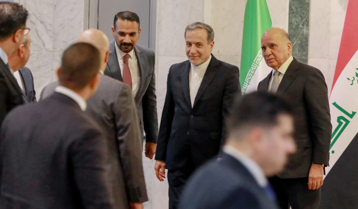 raqi Foreign Minister Fuad Hussein (R) welcomes his Iranian counterpart Seyed Abbas Araghchi (C) in Baghdad on October 13, 2024. (AFP)