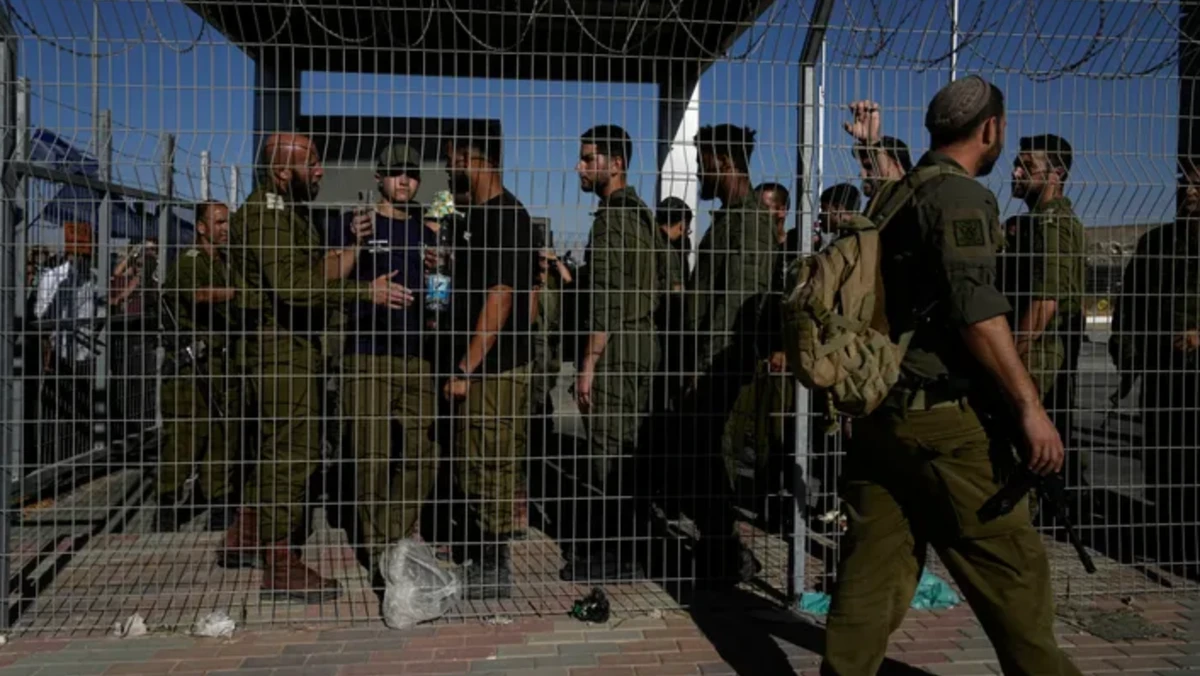 Israeli soldiers gather at the gate to the Sde Teiman military base in July 2024. (AP/File Photo)