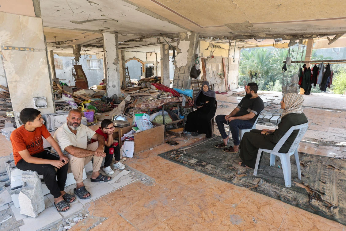 Palestinian Asmaa Al-Wasifi, whose son Yamen took his first polio vaccine in September and was killed in an Israeli strike before taking his second dose, sits next to her mother and brother Osama Al-Wasifi, father of four Palestinian children who were also killed in the same strike before taking the second dose, on Oct. 15, 2024. (Reuters)