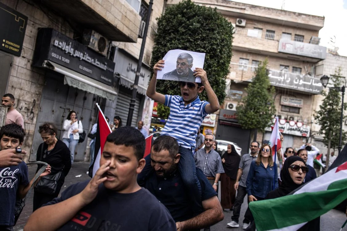 A young Palestinian boy holds up a portrait of slain Hamas leader Yahya Sinwar during a rally in Ramallah, in the Occupie-West Bank on Oct. 18, 2024. (AFP)