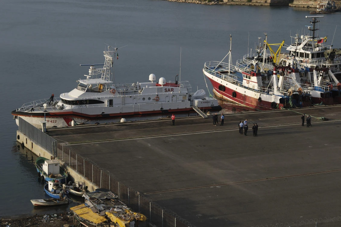 An Italian coast guard vessel prepares to depart from the port of Shengjin, Albania, to Italy, carrying 12 of 16 migrants intercepted in international waters and sent to the two reception facilities in Albania earlier this week after a court in Rome rejected their detention, on Saturday, Oct, 19, 2024. (AP)