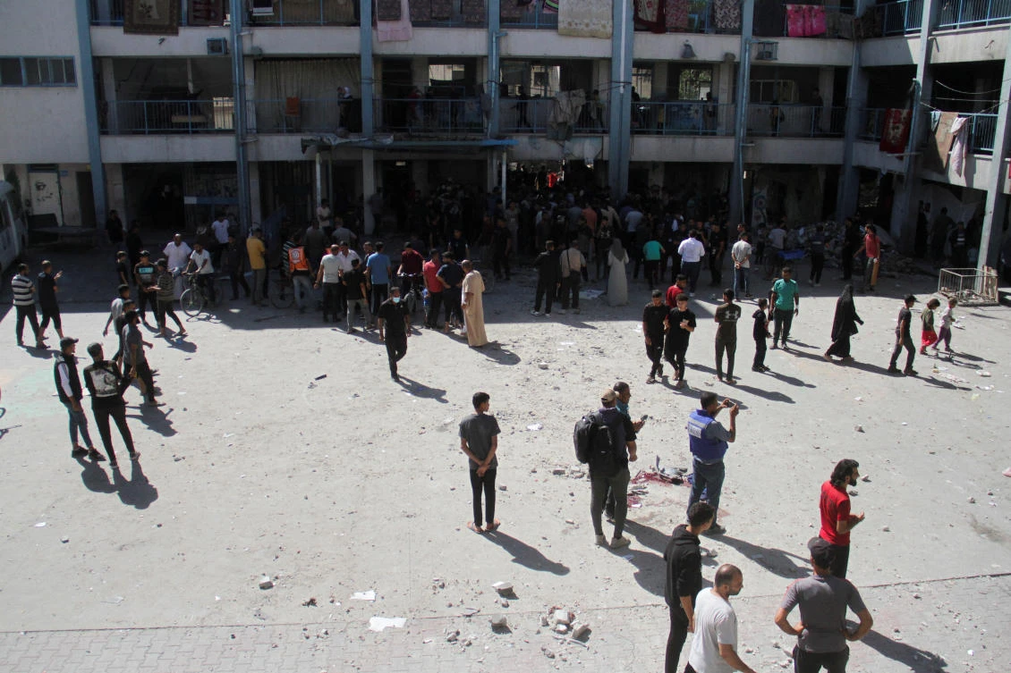 Palestinians inspect the site of an Israeli strike on a school sheltering displaced people, amid the ongoing Israel-Hamas conflict, at Beach refugee camp in Gaza City October 19, 2024. REUTERS/Mahmoud Issa