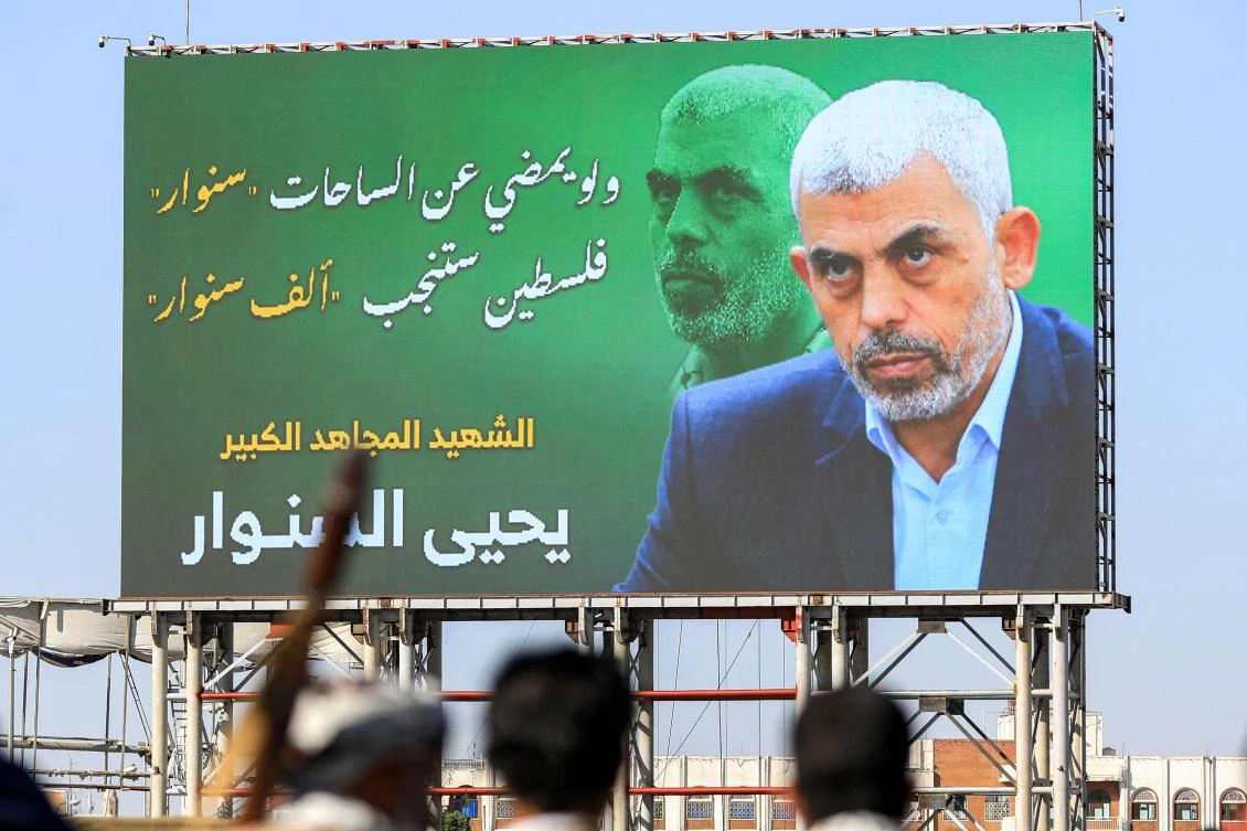 A billboard depicting Hamas’ slain leader Yahya Sinwar with the Arabic slogan “if Sinwar departs from the battlefields, Palestine will birth a thousand Sinwars,” during a rally in Yemen’s Houthi-controlled capital Sanaa on Oct. 18, 2024. (AFP)