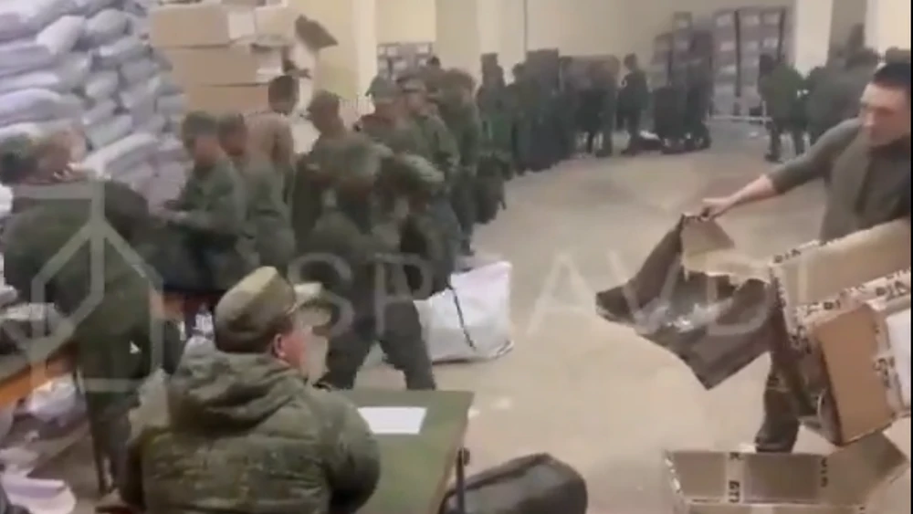A screengrab taken from a video, which was verified by Ukraine’s Center for Strategic Communications and Information Security, presumably showing North Korean soldiers stand in line to pick up bags, clothes and other apparel from Russian servicemen. (X/@BRICSinfo)