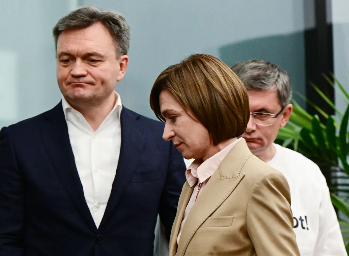 Moldova's President Maia Sandu (C), Prime Minister Dorin Recean (L) and President of the Parliament Igor Grosu (R) leave a press conference at her campaign headquarters in Chisinau October 21, 2024. (AFP)