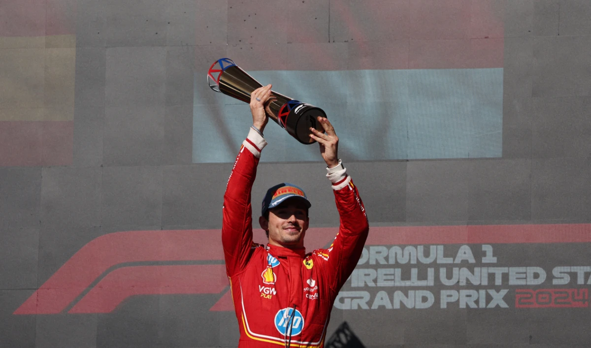Ferrari’s Charles Leclerc celebrates on the podium with a trophy after winning the US Grand Prix on Sunday. (Reuters)