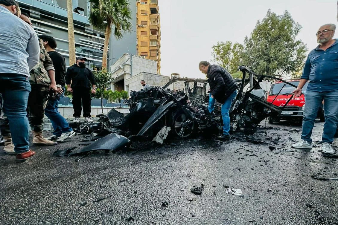 Syrian emergency and security services inspect the wreckage of a car that exploded in the Syrian Capital Damacus on October 21, 2024. (AFP)