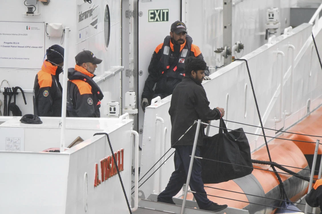 The first 12 migrants that Italy sent to a newly opened asylum processing center in Shengjin, Albania, disembark in the harbor of Bari, in southern Italy, Saturday, Oct. 19, 2024. (AP Photo)