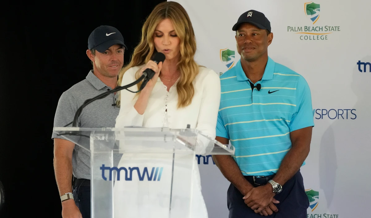 Host Erin Andrews, center, introduces golfers Tiger Woods, right, and Rory McIlroy during a news conference announcing the future home of TGL, a new tech-infused, team golf league, Feb. 21, 2023, on the campus of Palm Beach State College in Palm Beach Gardens, Fla. (File/AP)