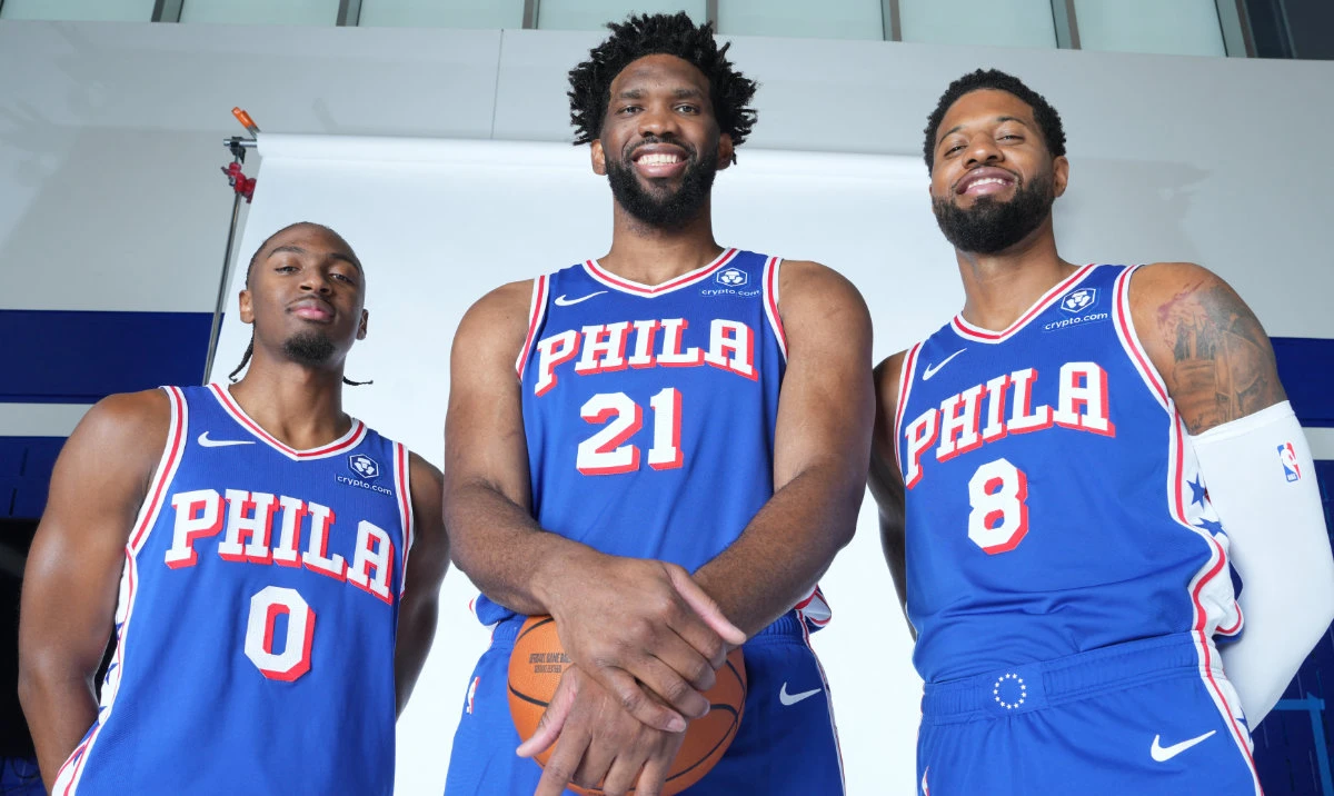Philadelphia 76ers Joel Embiid #21, and Paul George #8, with Tyrese Maxey, during NBA Media Day on Sept. 30, 2024, will both miss the Sixers’ opener due to injuries. (AFP)