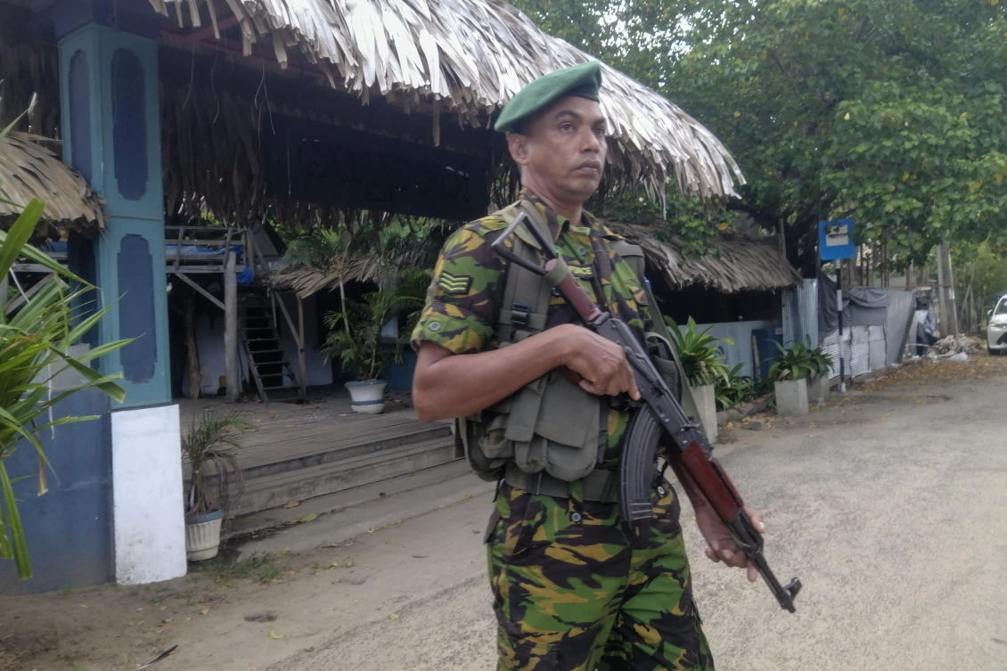 A police commando stands guard in front of a restaurant in Arugam Bay, Sri Lanka on Oct. 23, 2024. (AP)