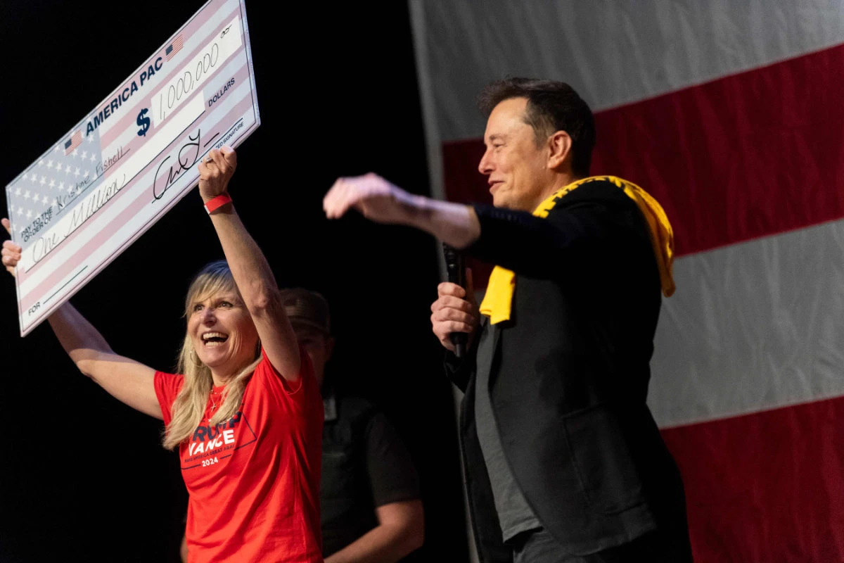 SpaceX and Tesla founder Elon Musk awarded Kristine Fishell with a $1 million check during the town hall at the Roxain Theater on October 20, 2024 in Pittsburgh, Pennsylvania. (Getty Images/AFP)