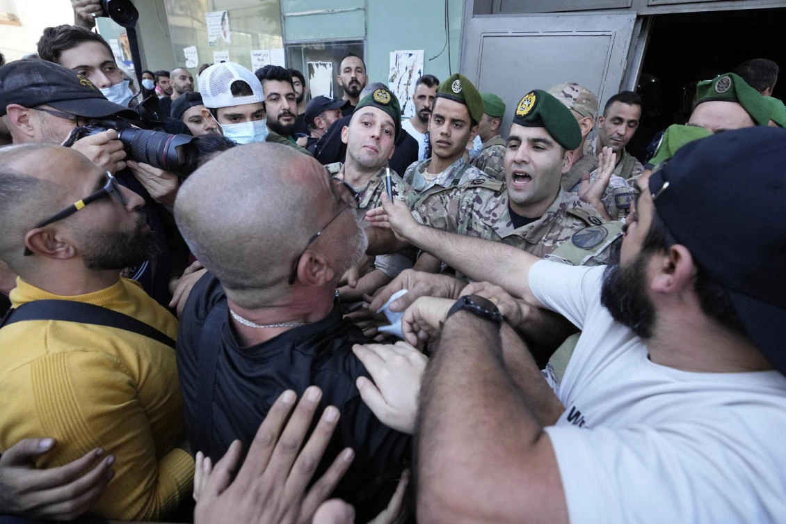 People displaced by the conflict between Israel and Hezbollah resist an attempted eviction by Lebanese security forces on Hamra Street, Beirut, Lebanon, Monday, Oct. 21, 2024. (AP Photo)