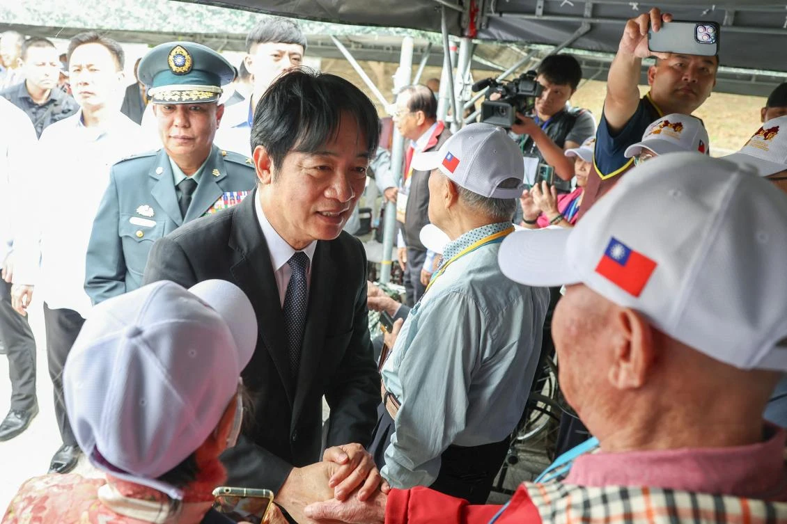 Taiwan’s President Lai Ching-te, left, shakes hands with veterans during a ceremony commemorating the 75th anniversary of the Battle of Guningtou in Kinmen on Oct. 25, 2024. (AFP)