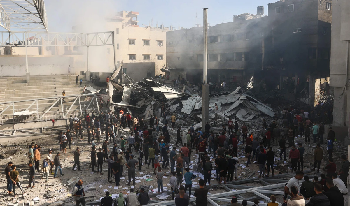 Palestinians gather around the rubble of the Maghazi Camp Services Club building following an Israeli strike on the Maghazi refugee camp in the Gaza Strip on October 24, 2024, amid the ongoing war between Israel and Hamas. (AFP)