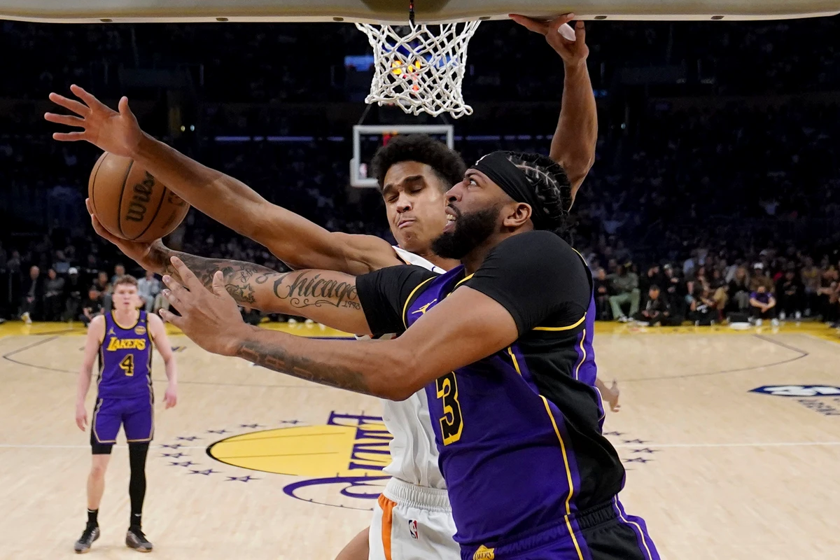 Los Angeles Lakers forward Anthony Davis goes to the basket against Phoenix Suns center Oso Ighodaro during the first half of an NBA basketball game in Los Angeles. (AP)