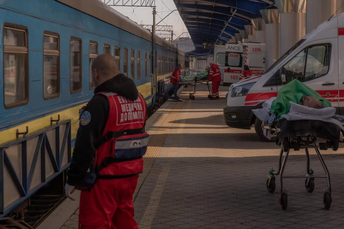Injured Ukrainian soldiers are moved on stretchers from ambulances to a military evacuation train transporting Ukrainian servicemen wounded in frontline areas to hospitals, in an undisclosed location amid the Russian invasion of Ukraine. (AFP)