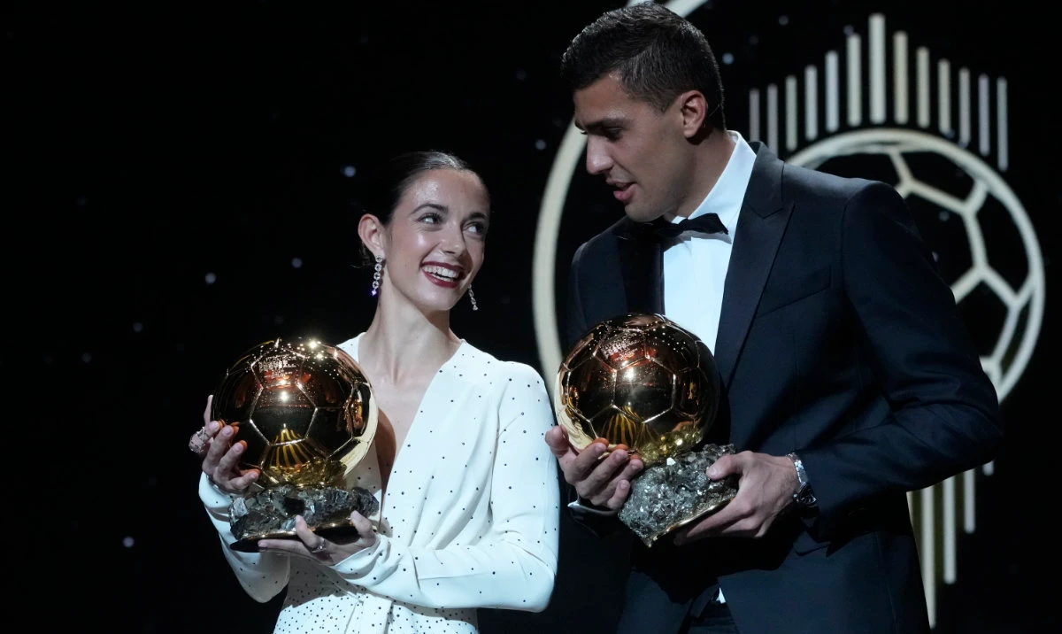 Barcelona's Spanish player Aitana Bonmati, left, and Manchester City's Spanish player Rodri hold their 2024 Ballon d'Or trophies during the 68th Ballon d'Or (Golden Ball) award ceremony at Theatre du Chatelet in Paris, Monday, Oct. 28, 2024. (AP)