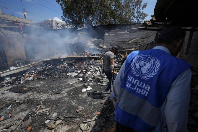 Palestinians look at the destruction after an Israeli strike on a school run by UNRWA, in Nuseirat, Gaza Strip. (File/AP)