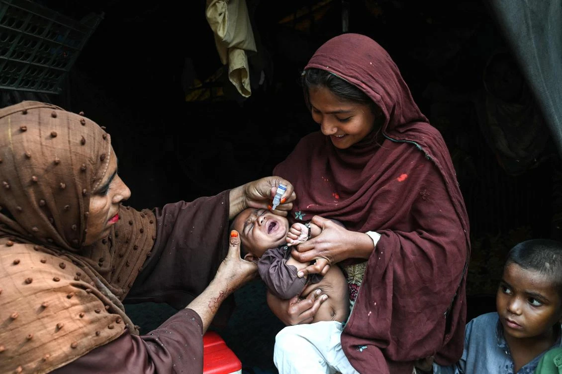 A health worker administers polio drops to a child during a door-to-door vaccination campaign in Lahore on October 28, 2024. (AFP)