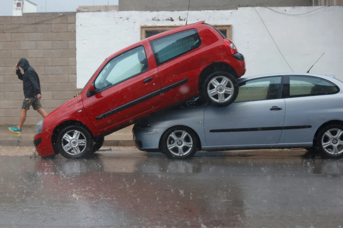 A car sits partially on top of another after the Spanish meteorological agency put the Valencia region in the highest red alert for extreme rainfalls, in Llombai, Valencia, Spain. (REUTERS/Eva Manez)