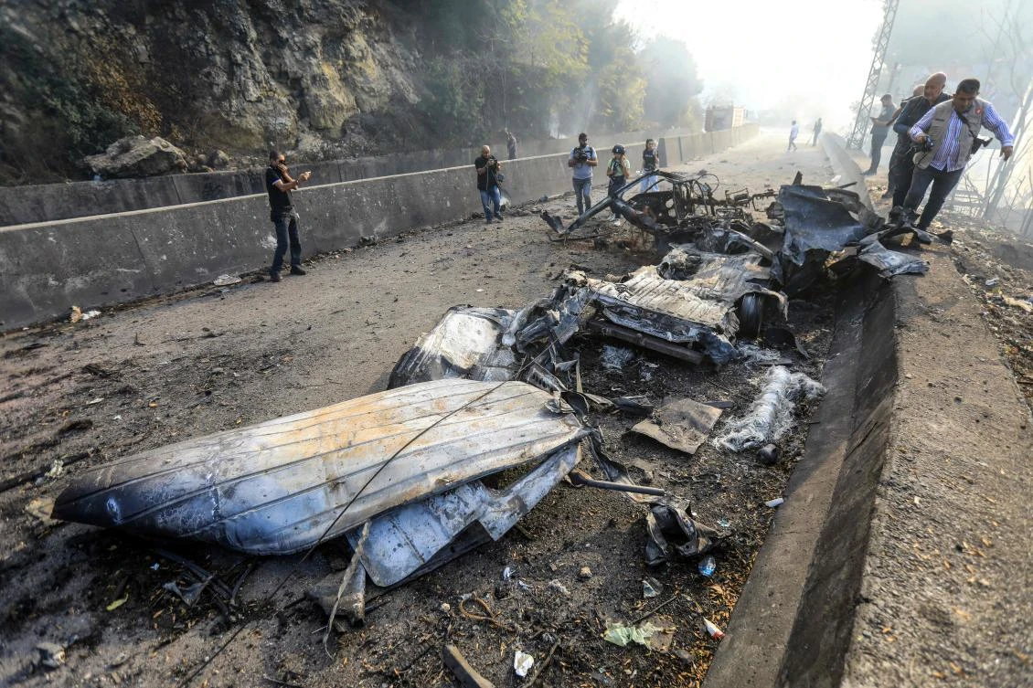 The wreckage of a vehicle lies on the Araya-Kahhale road on October 30, 2024, at the site of an Israeli strike. (AFP)