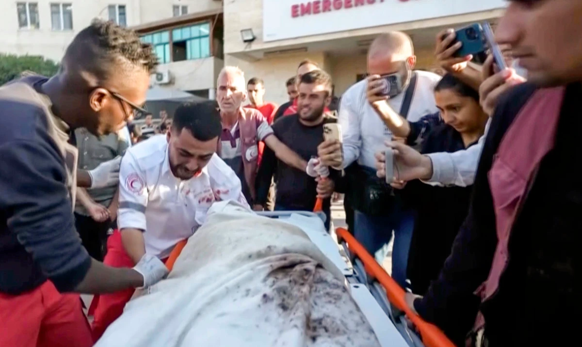 In this image made from an Associated Press video, medic Abed Al Aziz Bardini cries over the body of his mother after he realizes it's her, shouting in Arabic, "Oh god, I swear she is my mother. I didn't know it was her," on Wednesday, Oct. 30, 2024, in Deir al-Balah on the Gaza Strip. (AP)