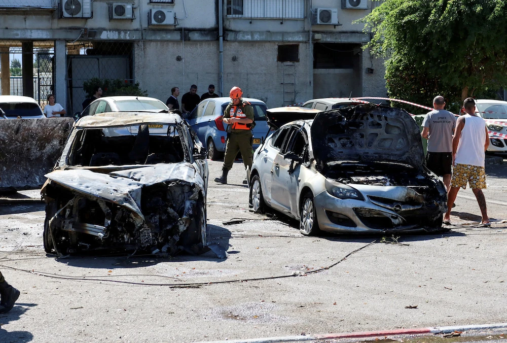 Israeli Home Front Command soldier at the scene following rockets that were launched from Lebanon towards Israel. (Reuters)
