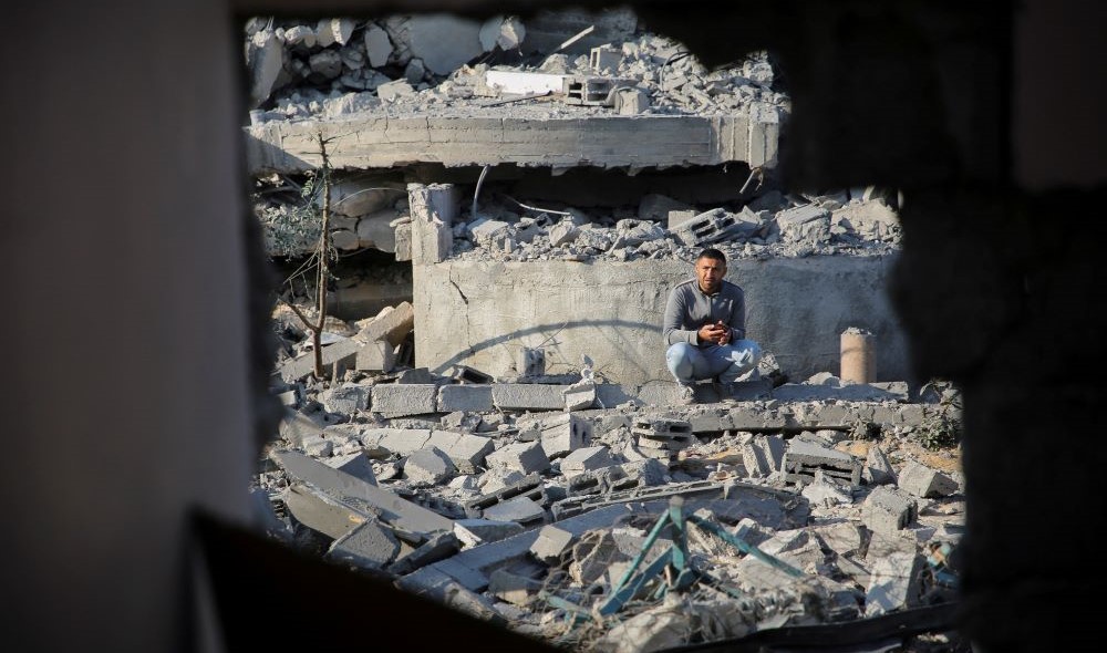 A Palestinian man sits amidst rubble after intensive Israeli air strikes, Khan Younis, Gaza, Nov. 6, 2024. (Reuters)