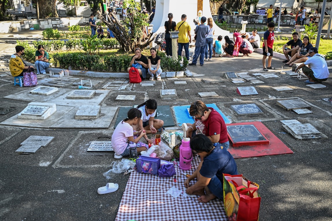 Filipinos honor their dead with flowers, food in All Saints’ Day rites