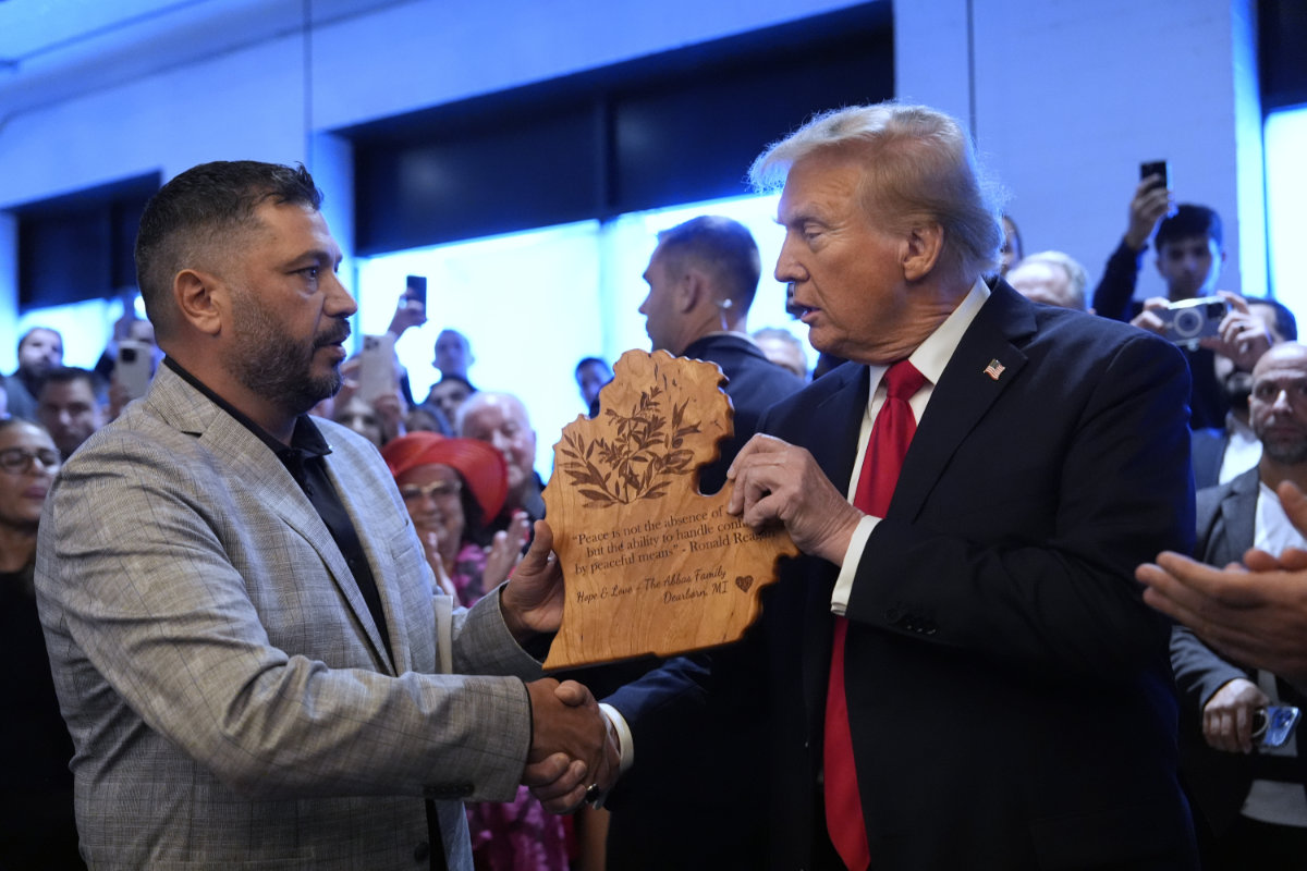 Republican presidential nominee former President Donald Trump shakes hands with owner Albert Abbas as he visits The Great Commoner restaurant on Nov. 1, 2024, in Dearborn, Michigan. (AP)