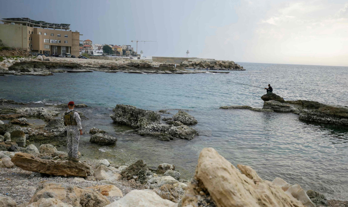 Lebanese soldiers inspect the beach at a reported landing site for a "naval commando force" which abducted a Lebanese mariner according to a military source, in the northern coastal town of Batroun on November 2, 2024. (AFP)